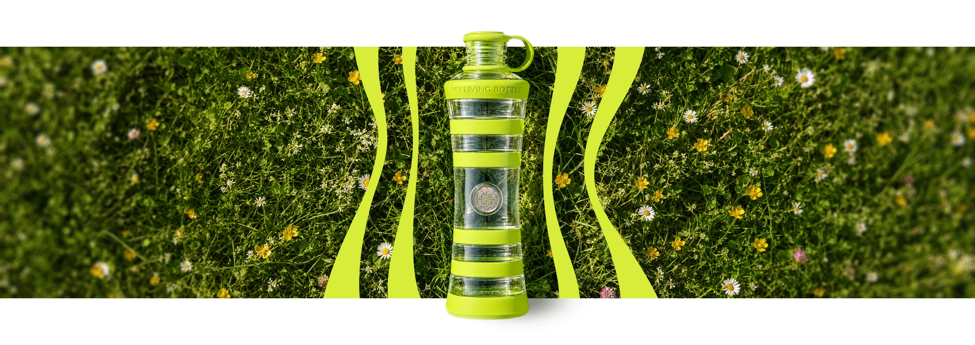 VIREA glass bottle lying in a flowering meadow